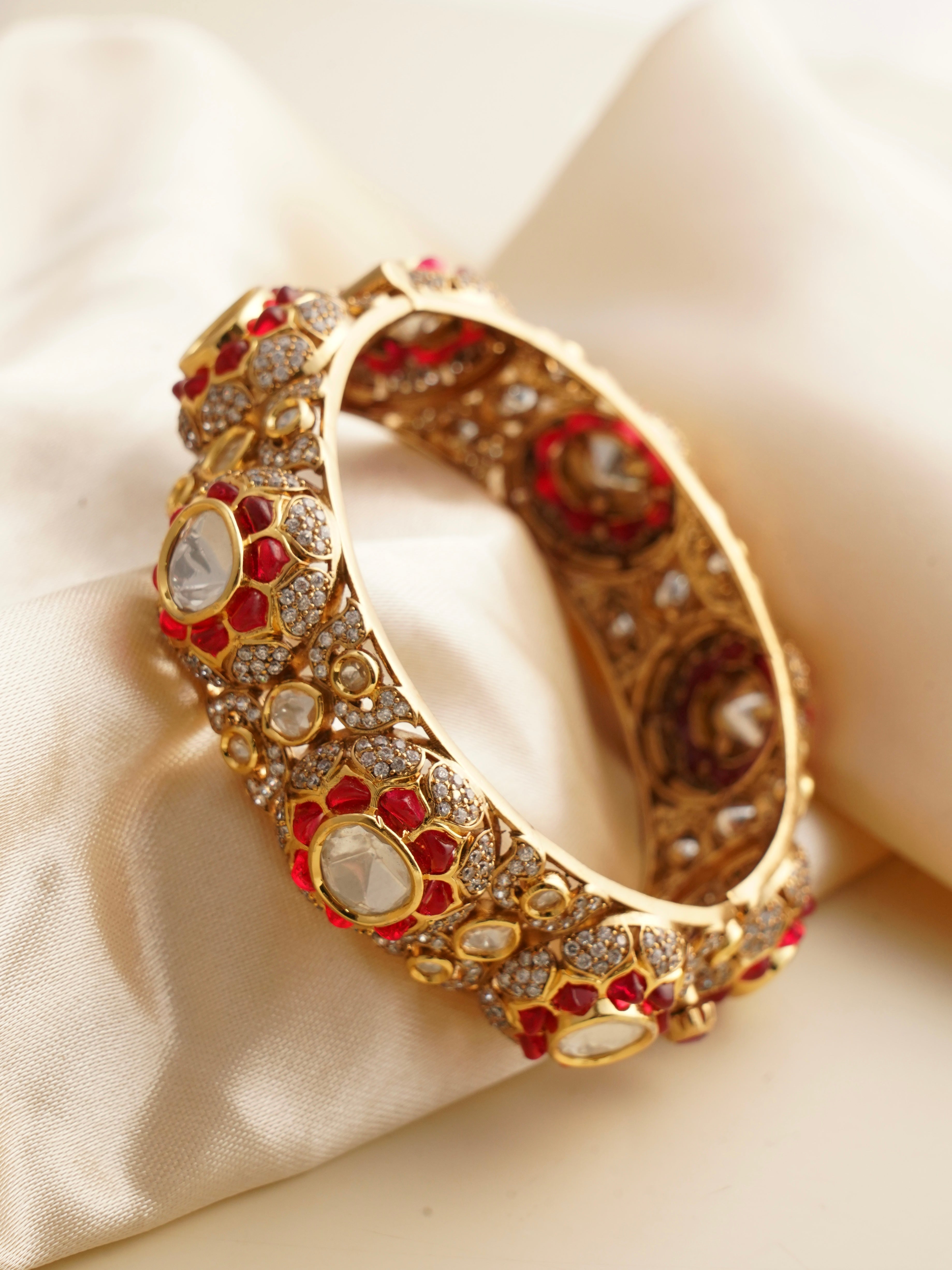 Side angle of kada showing uncut polki stones and engraved jaali inner rim